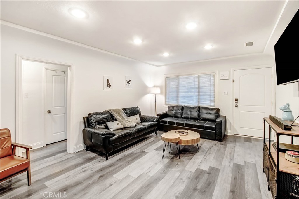 9732 Belmont Drive Riverside, CA 92503 - Photo 2 of 20 a living room with furniture and a flat screen tv