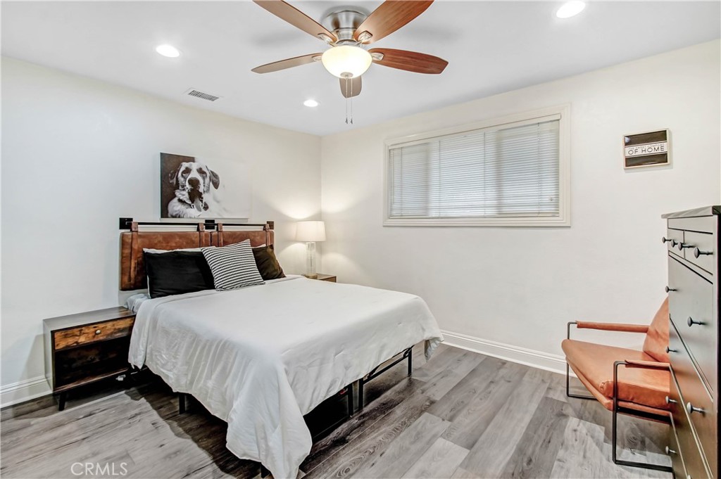 9732 Belmont Drive Riverside, CA 92503 - Photo 9 of 20 a bedroom with a bed and a chair