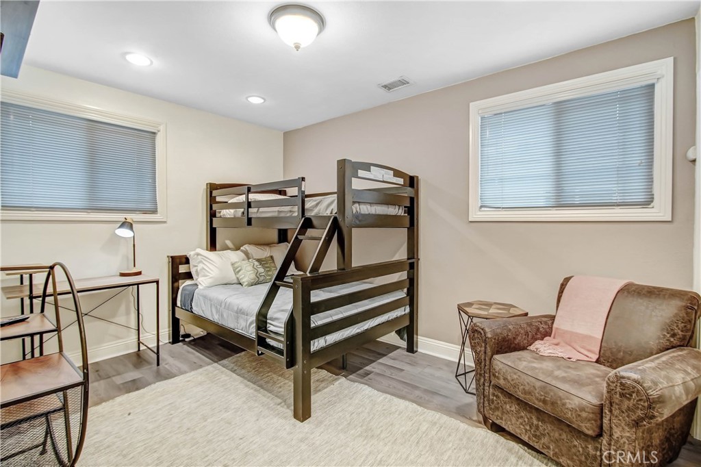 9732 Belmont Drive Riverside, CA 92503 - Photo 10 of 20 a bedroom with furniture and a wooden floor