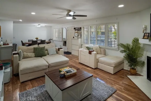 a living room with furniture ceiling fan and a rug