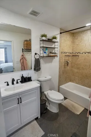 a bathroom with a sink toilet vanity and shower