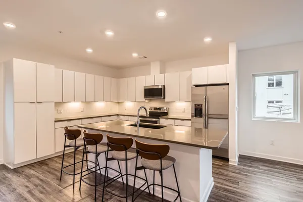 a kitchen with stainless steel appliances a sink stove and refrigerator
