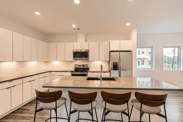 a view of a hallway with closet and a window