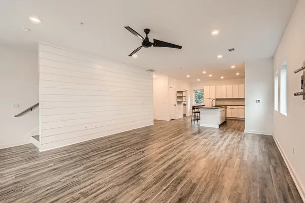 a view of a kitchen with a sink and wooden floor