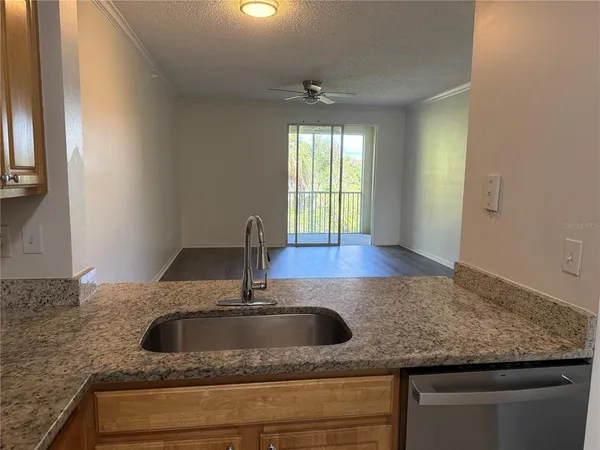 a kitchen with granite countertop a sink a window and a granite counter tops