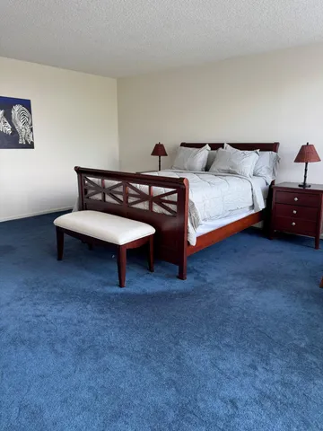 a bedroom with a bed and a chair