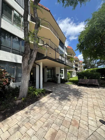 a front view of a building with a garden
