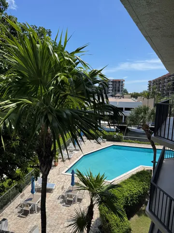 a view of a swimming pool and lounge chair