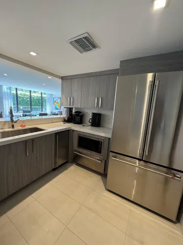 a kitchen with stainless steel appliances granite countertop a refrigerator sink and cabinets