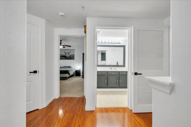 a bathroom with a tub shower and a sink