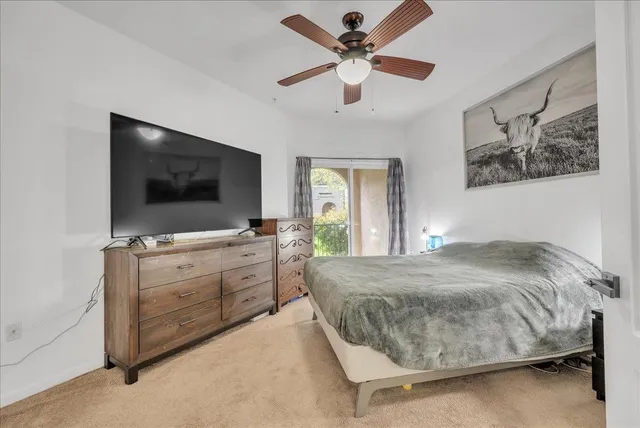 a bedroom with a large bed and a flat screen tv