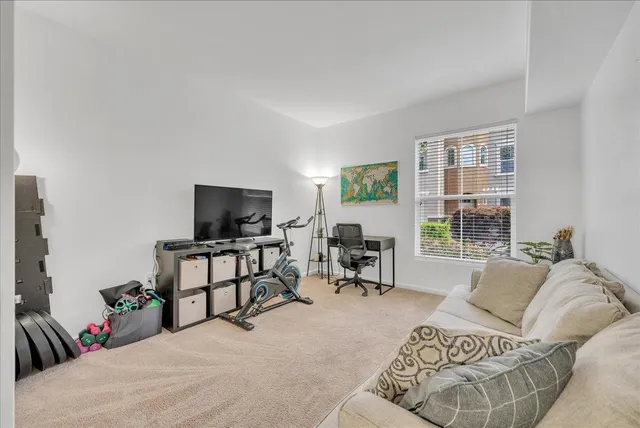 a bedroom with furniture and a flat screen tv
