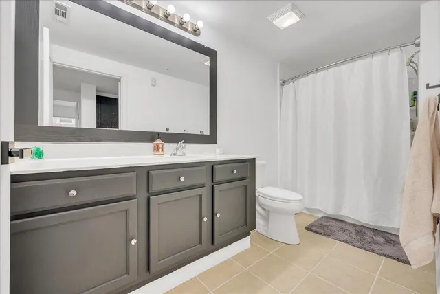 a bathroom with a toilet a sink and a mirror