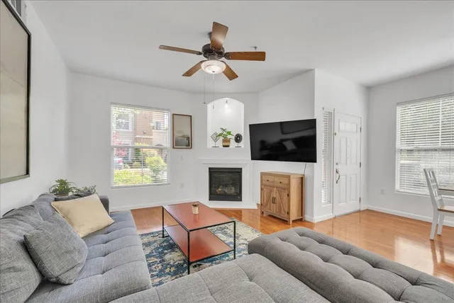 a living room with furniture a flat screen tv and a fireplace