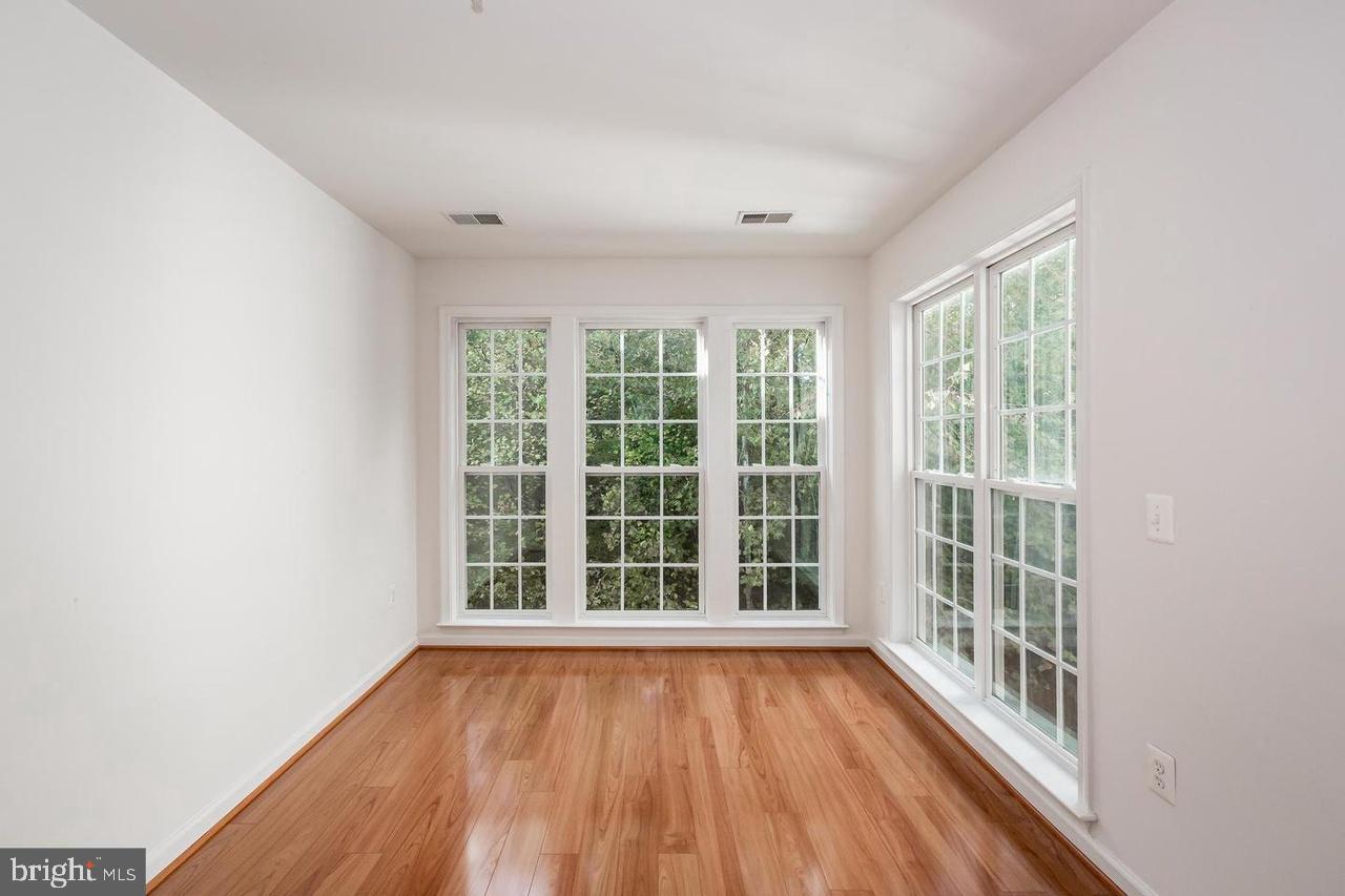 13953 Lullaby Road Germantown, MD 20874 - Photo 11 of 26 wooden floor in an empty room with a window