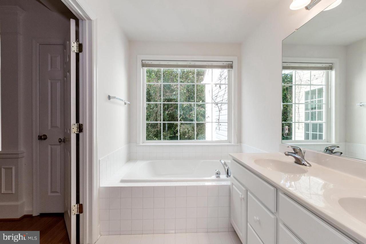 13953 Lullaby Road Germantown, MD 20874 - Photo 13 of 26 a bathroom with a bathtub and a sink