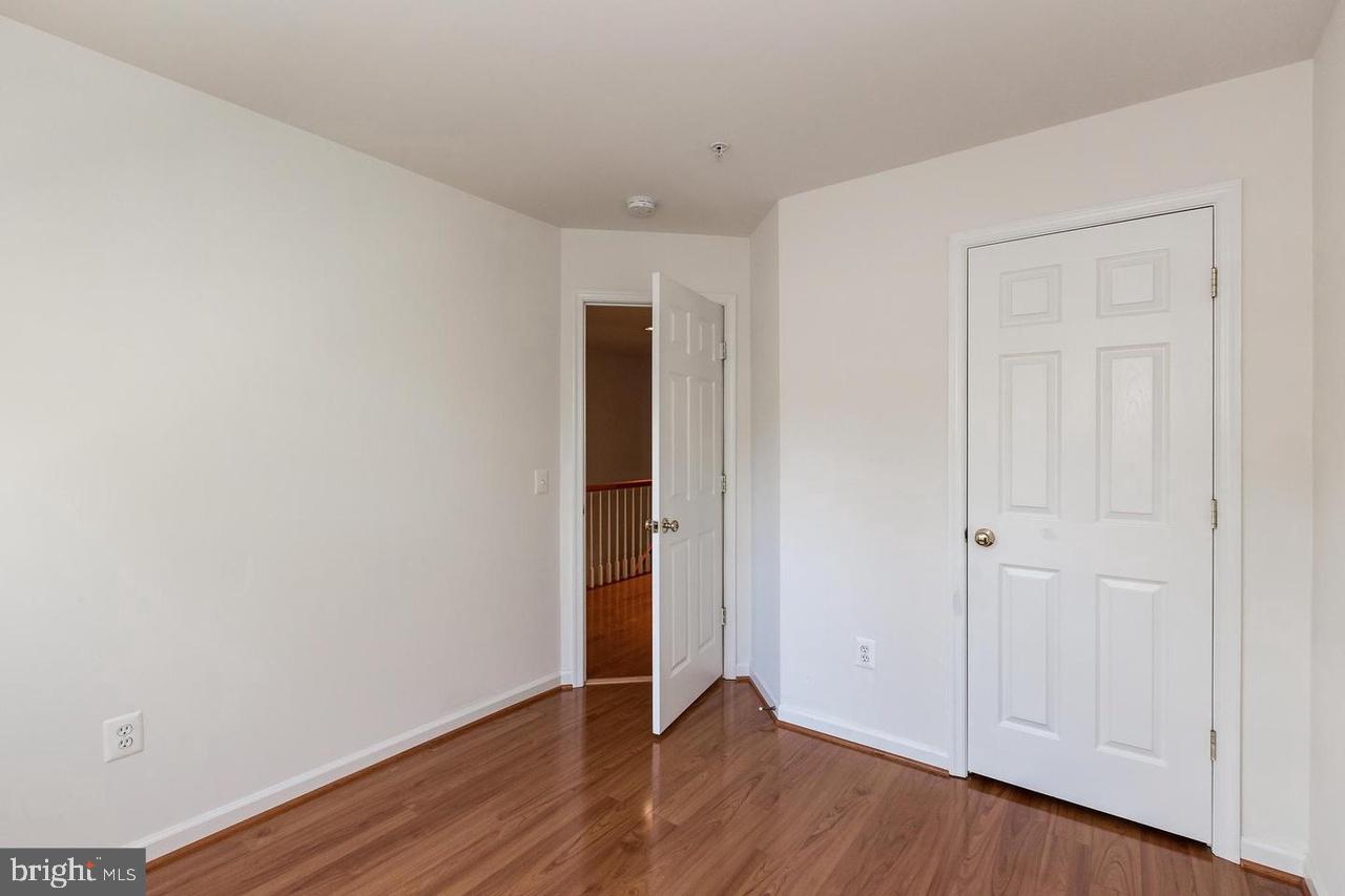 13953 Lullaby Road Germantown, MD 20874 - Photo 18 of 26 a view of an empty room with wooden floor