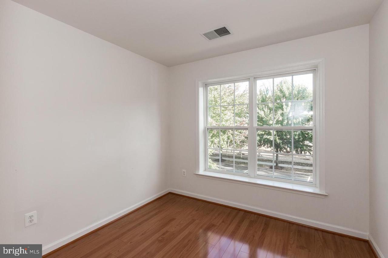 13953 Lullaby Road Germantown, MD 20874 - Photo 19 of 26 a view of an empty room with wooden floor and a window