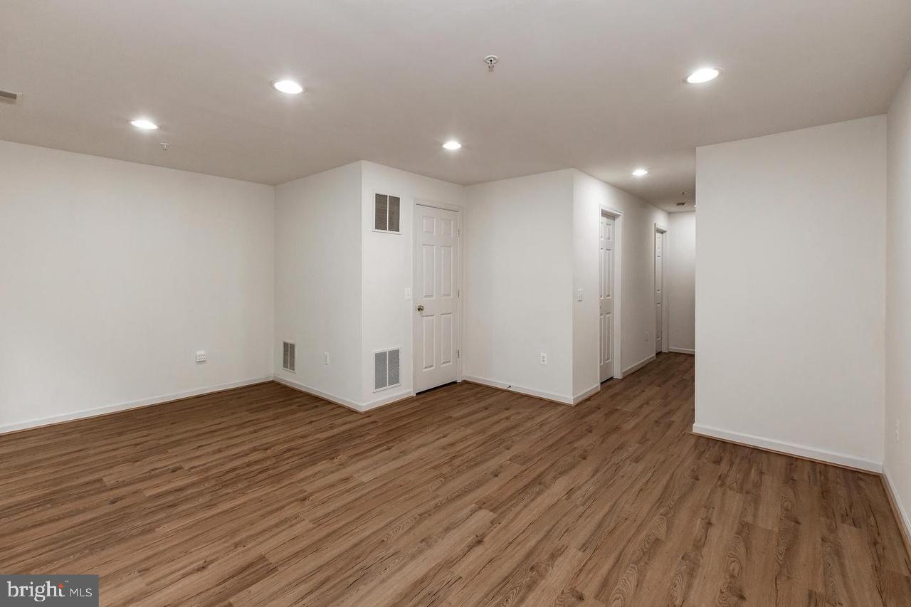 13953 Lullaby Road Germantown, MD 20874 - Photo 22 of 26 an empty room with wooden floor and windows