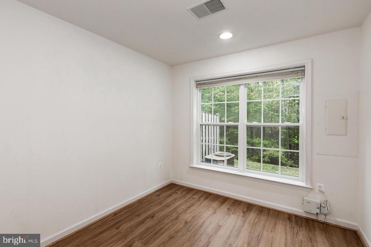 13953 Lullaby Road Germantown, MD 20874 - Photo 23 of 26 a view of an empty room with wooden floor and a window
