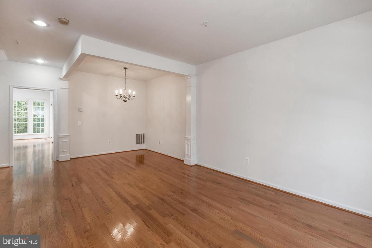 13953 Lullaby Road Germantown, MD 20874 - Photo 3 of 26 a view of empty room with wooden floor and fan