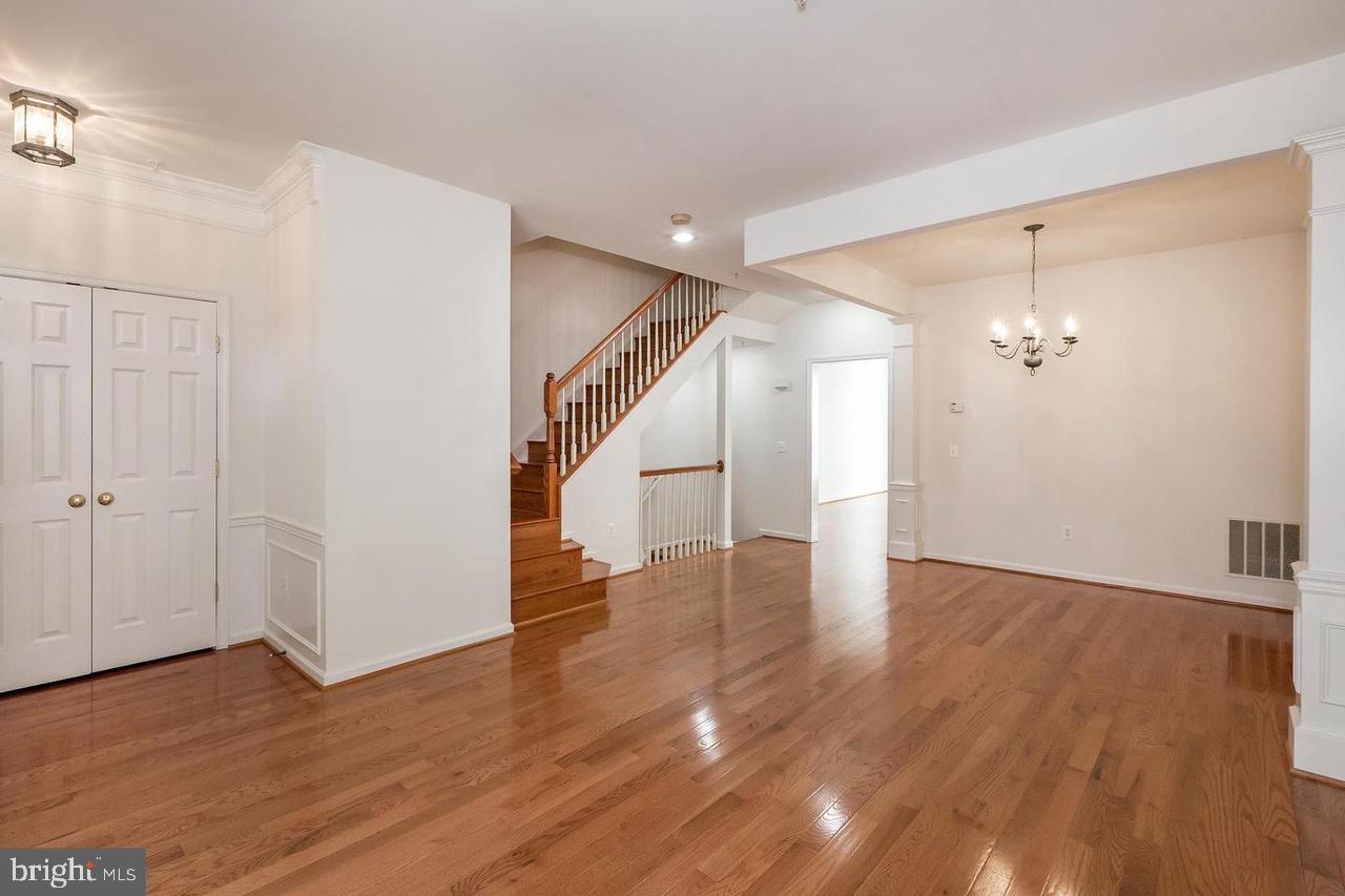13953 Lullaby Road Germantown, MD 20874 - Photo 4 of 26 a view of a hallway with wooden floor
