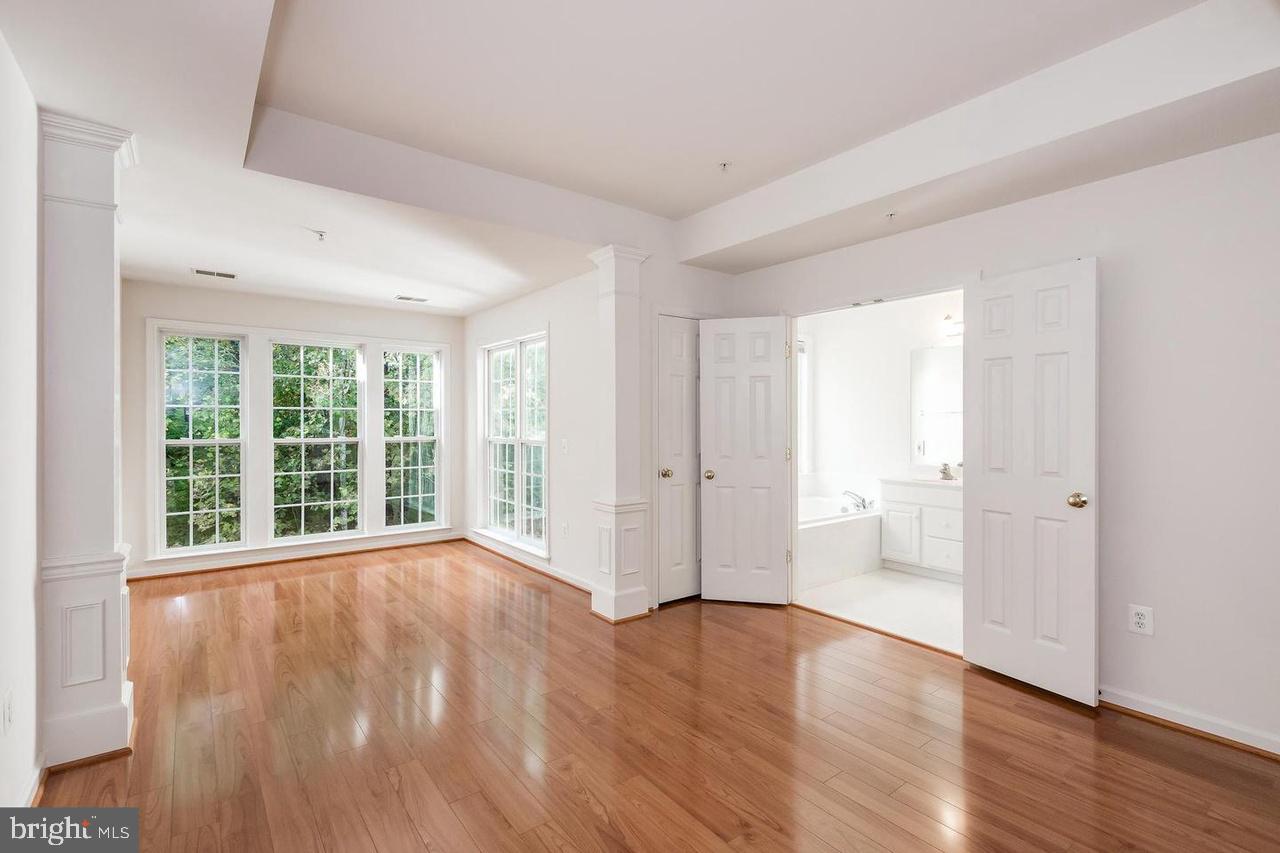 13953 Lullaby Road Germantown, MD 20874 - Photo 10 of 26 a view of an empty room with wooden floor and a window