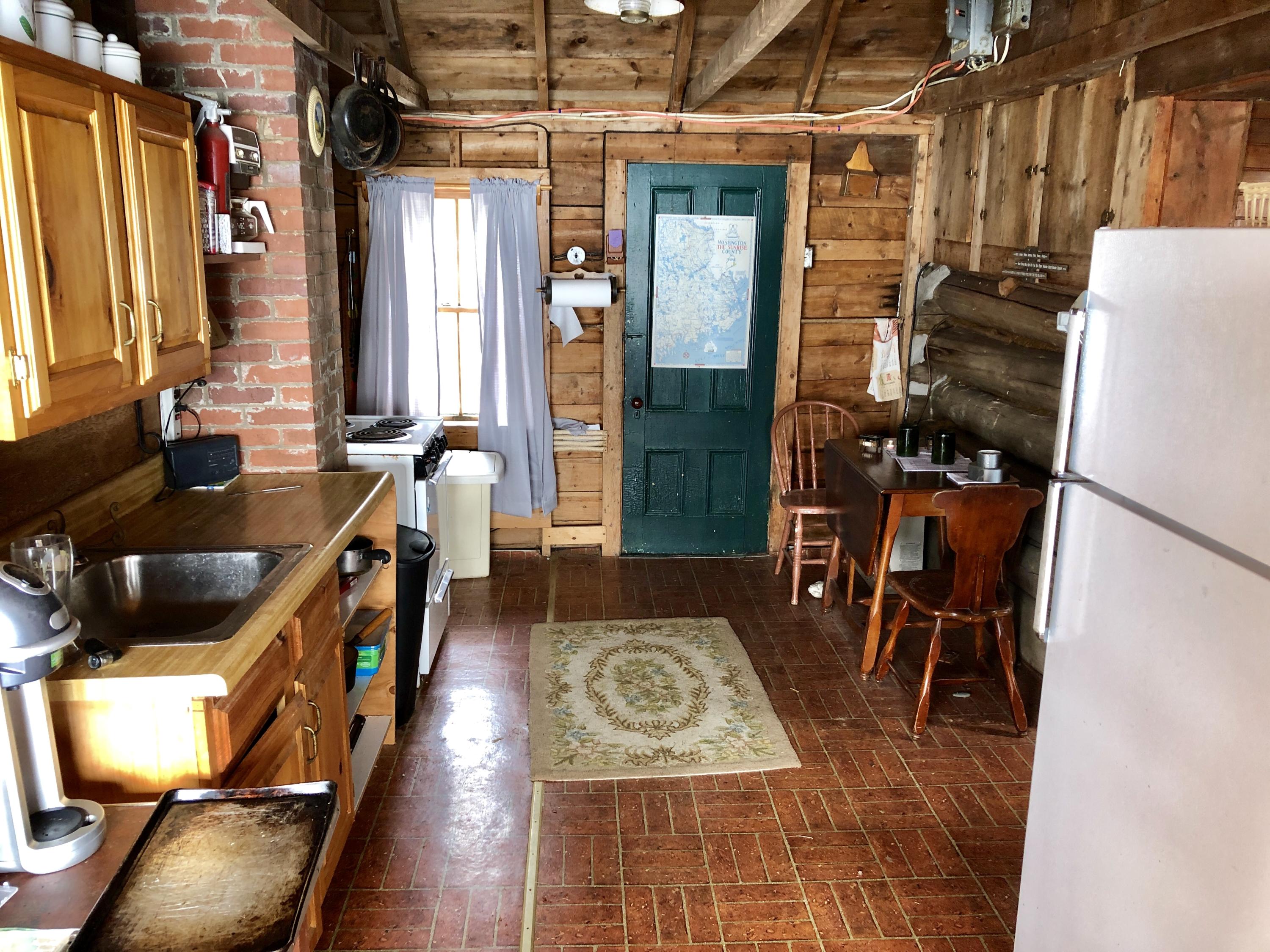 35 Lupine Way Perry, ME 04667 - Photo 13 of 32 35 Lupine Way, log cabin, kitchen toward