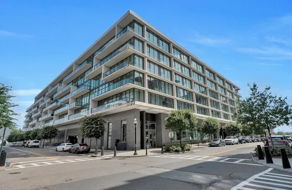 a man walking down a street next to a building