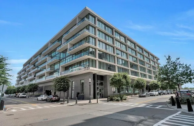 a man walking down a street next to a building