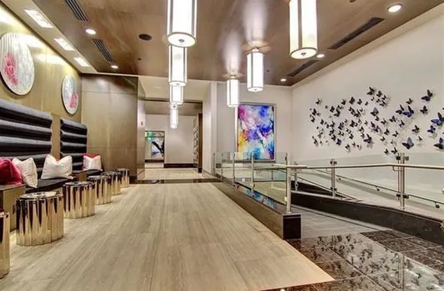 a kitchen with stainless steel appliances a stove refrigerator sink and wooden floor