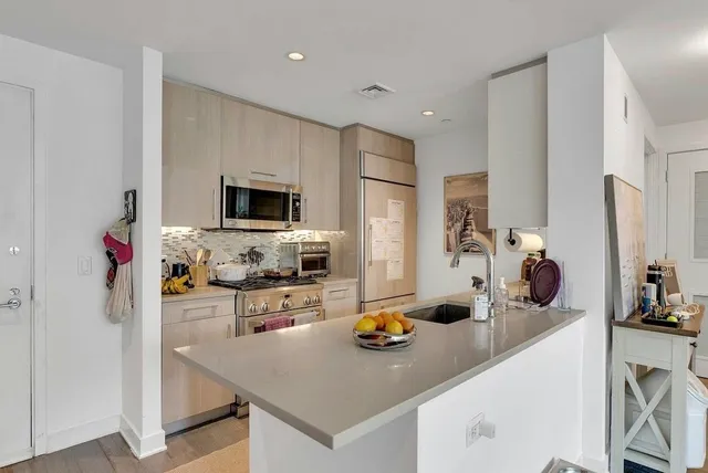 a kitchen with stainless steel appliances granite countertop a stove and a sink