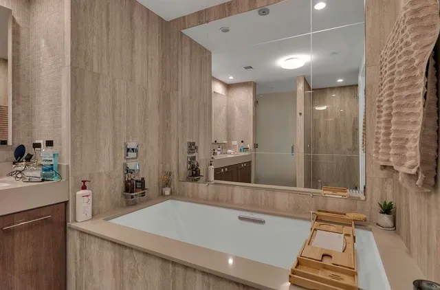a bathroom with a granite countertop sink a toilet and shower