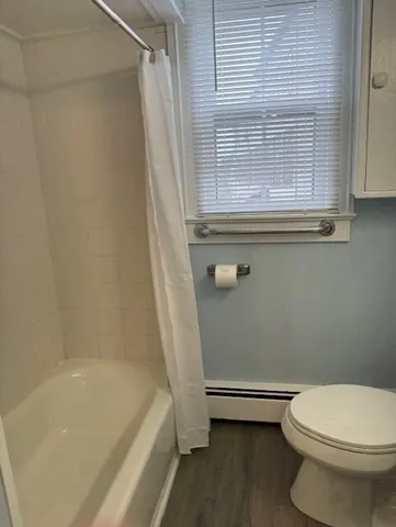 a bathroom with a toilet a sink and bathtub