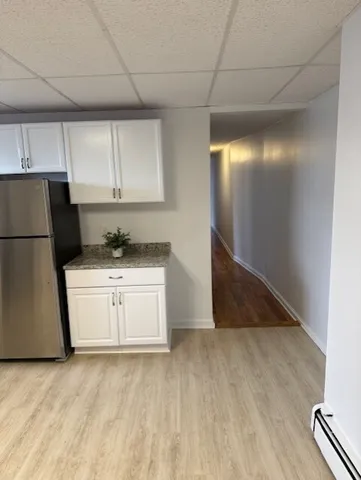 a kitchen with a refrigerator sink and cabinets