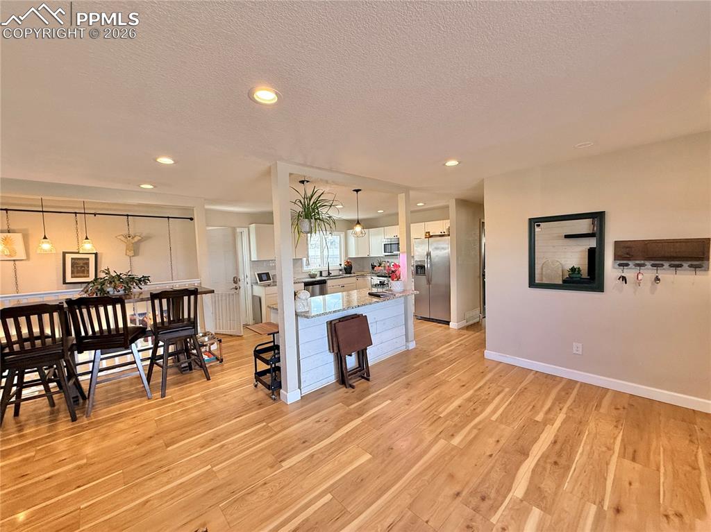 58 Duke Street Pueblo, CO 81005 - Photo 12 of 35 a living room with furniture and kitchen view with wooden floor
