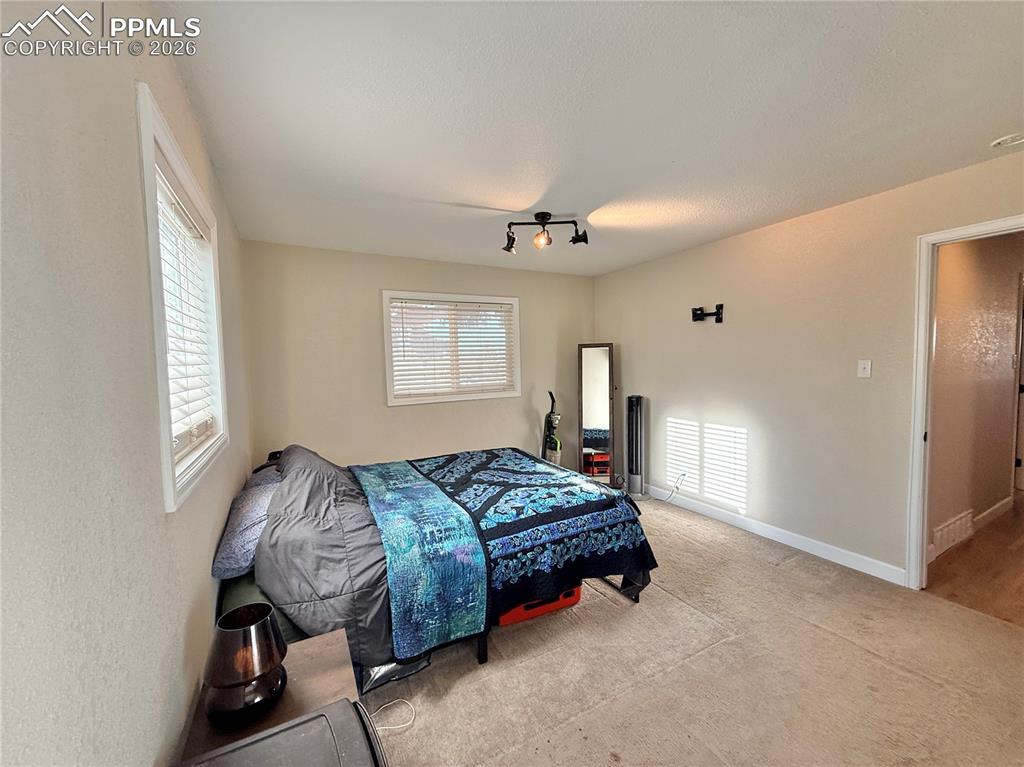 58 Duke Street Pueblo, CO 81005 - Photo 19 of 35 a spacious bedroom with a bed and window