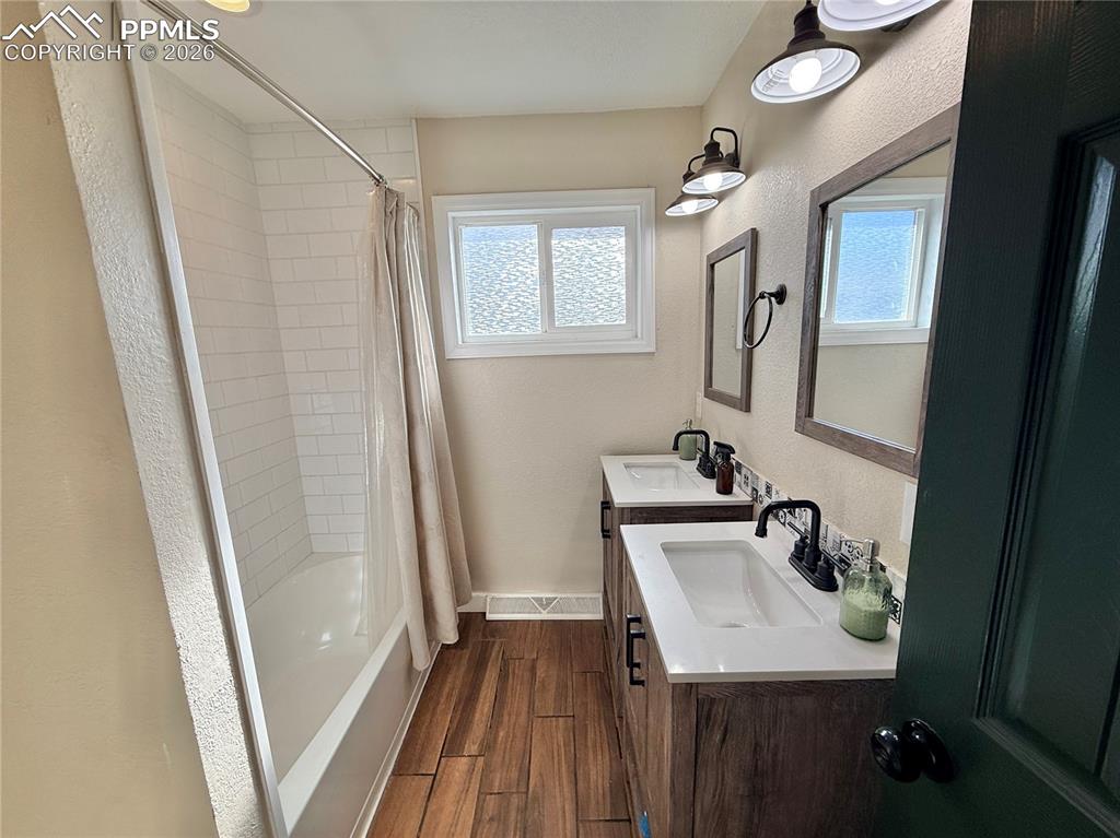 58 Duke Street Pueblo, CO 81005 - Photo 32 of 35 a bathroom with a sink a mirror and a shower
