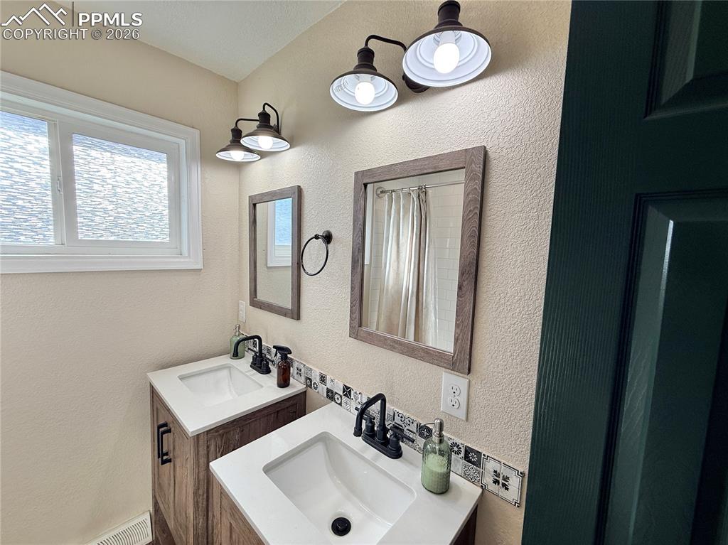 58 Duke Street Pueblo, CO 81005 - Photo 33 of 35 a bathroom with a sink and a mirror