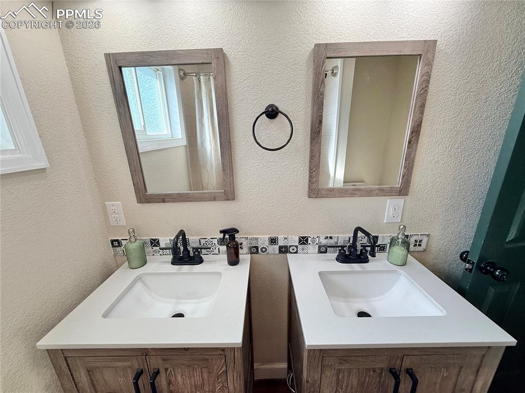 58 Duke Street Pueblo, CO 81005 - Photo 34 of 35 a bathroom with a sink and a mirror