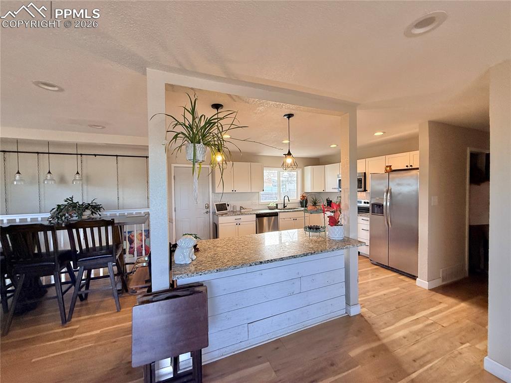 58 Duke Street Pueblo, CO 81005 - Photo 6 of 35 a kitchen with stainless steel appliances granite countertop a refrigerator and a view of living room