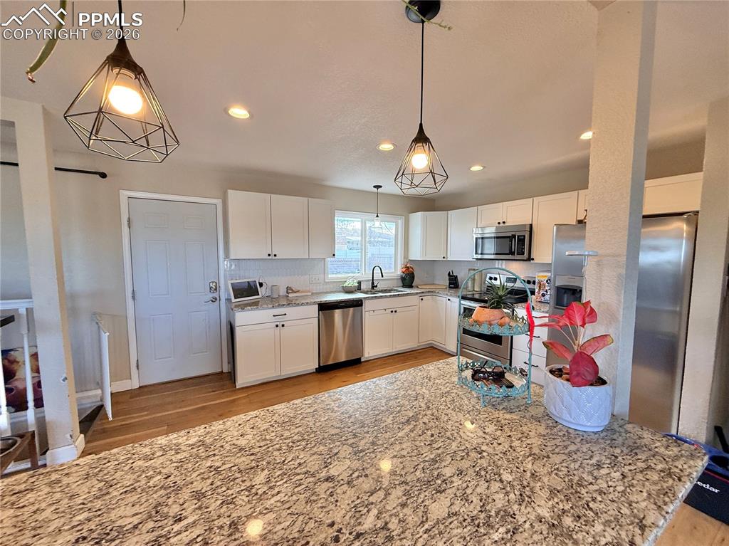 58 Duke Street Pueblo, CO 81005 - Photo 7 of 35 a kitchen with stainless steel appliances granite countertop a sink refrigerator and cabinets