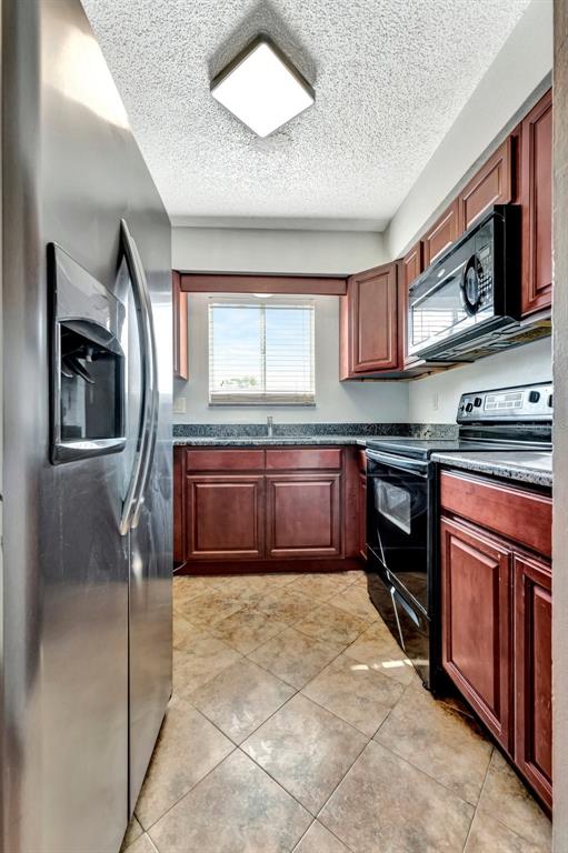 13300 Walsingham Road, Unit 56 Largo, FL 33774 - Photo 17 of 35 a kitchen with stainless steel appliances granite countertop a stove microwave and sink
