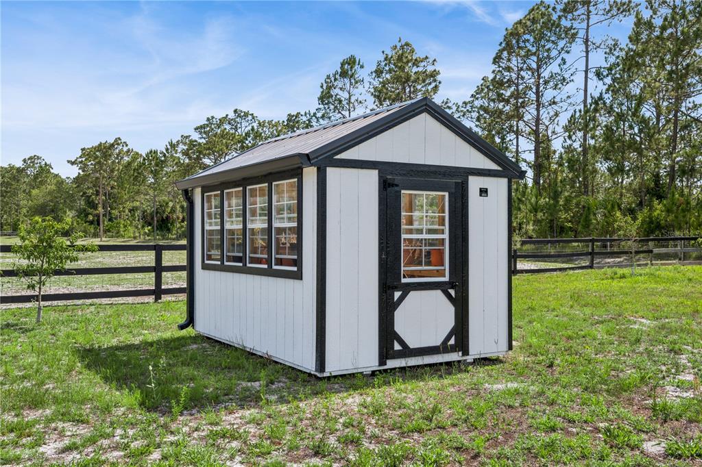 345 Cypress Isles Road Osteen, FL 32764 - Photo 35 of 41 a view of backyard with large trees and wooden fence