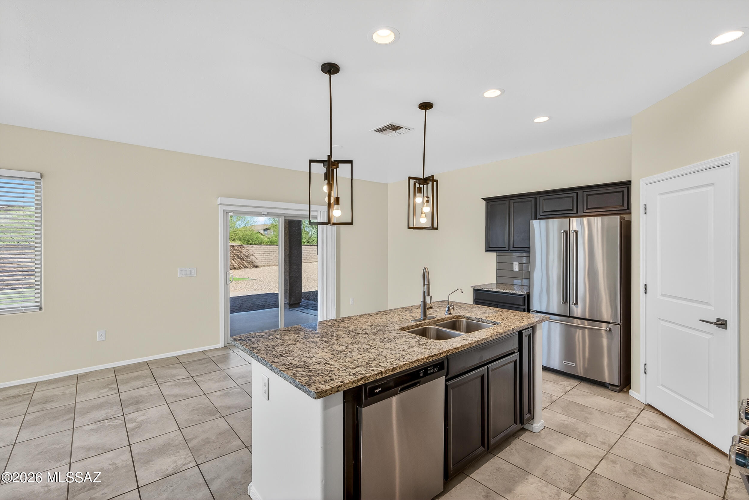 7556 South Circulo Rio Blanco Tucson, AZ 85756 - Photo 13 of 50 Open-concept kitchen, seamlessly overlooking the dining area with direct access to the covered backyard patio.