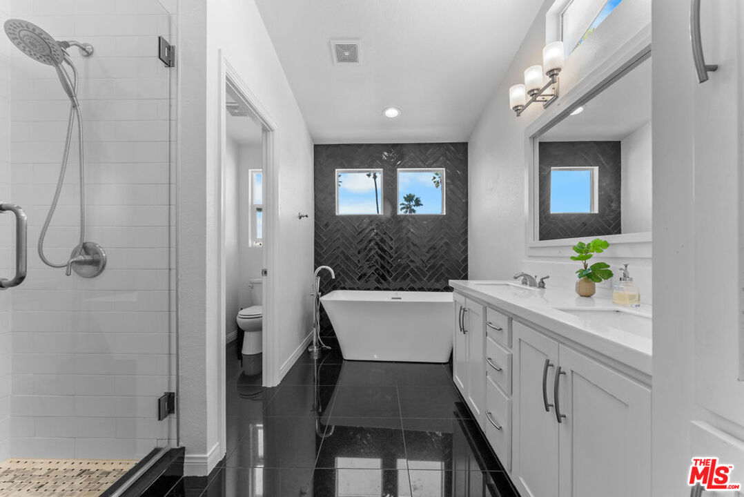29500 Heathercliff Road, Unit 70 Malibu, CA 90265 - Photo 13 of 38 a bathroom with a sink a mirror and a shower