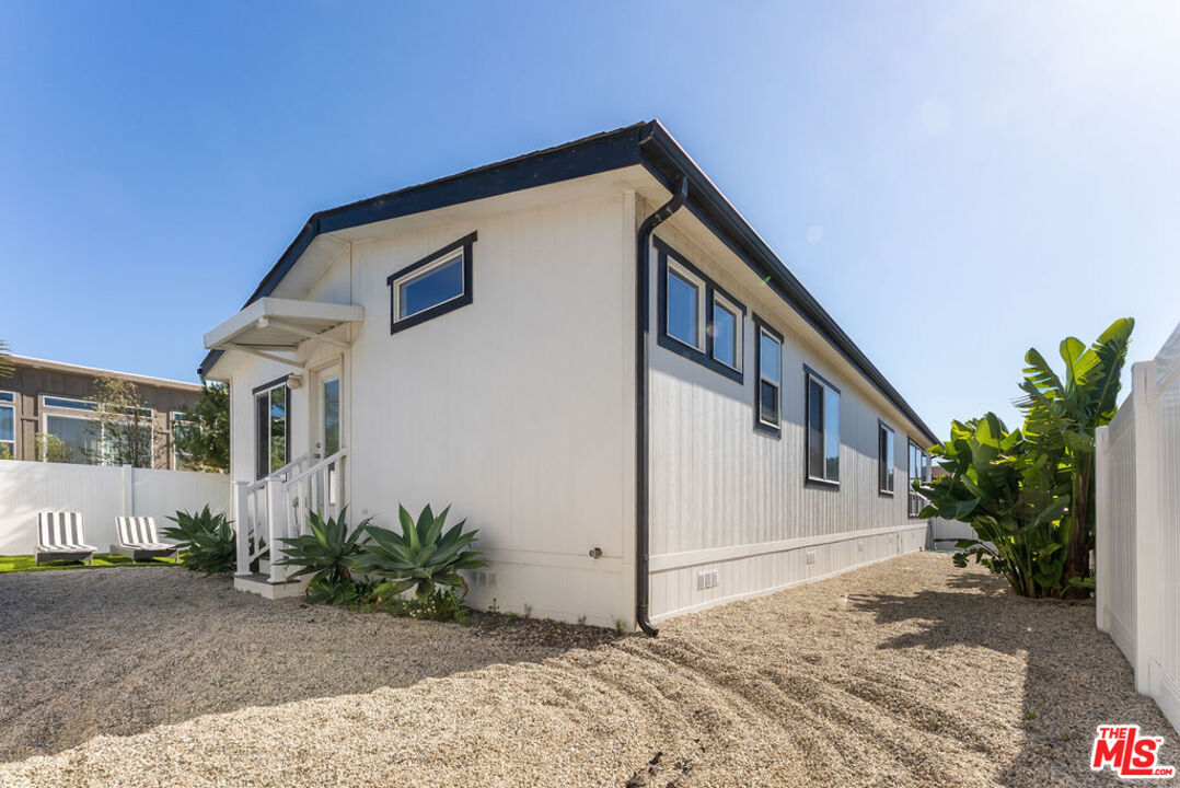 29500 Heathercliff Road, Unit 70 Malibu, CA 90265 - Photo 19 of 38 a front view of a house with a yard
