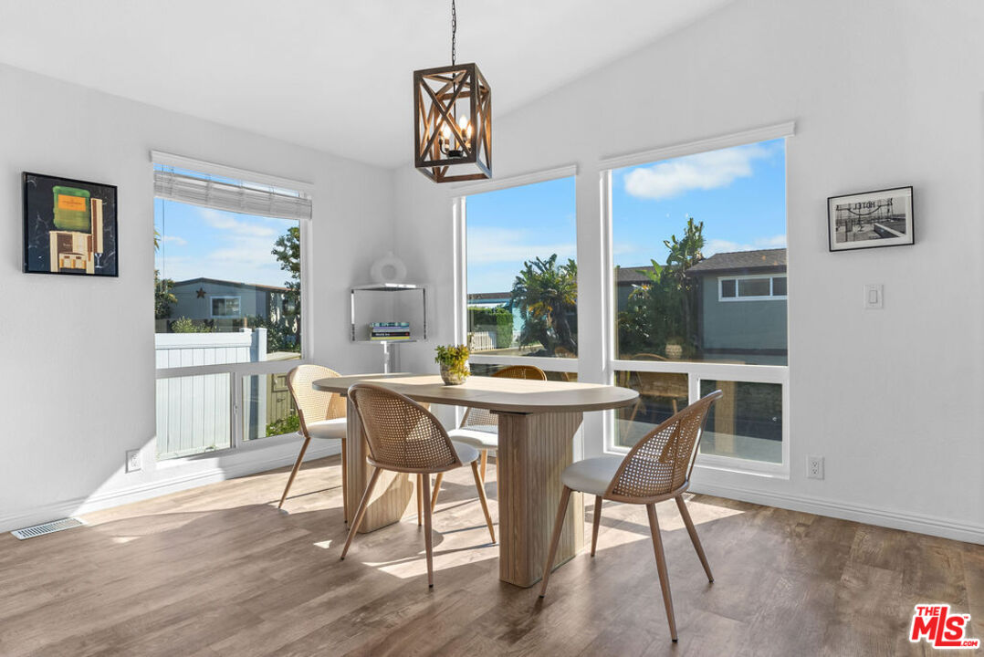 29500 Heathercliff Road, Unit 70 Malibu, CA 90265 - Photo 4 of 38 a view of a dining room with furniture window and wooden floor