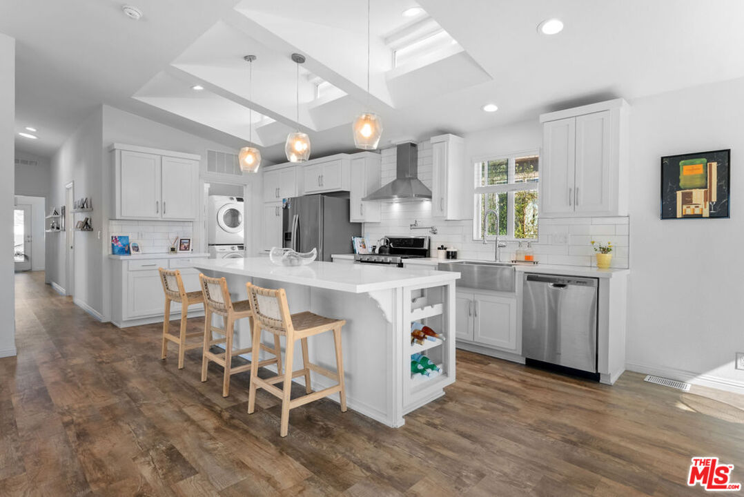 29500 Heathercliff Road, Unit 70 Malibu, CA 90265 - Photo 5 of 38 a kitchen that has a lot of white cabinets and stainless steel appliances