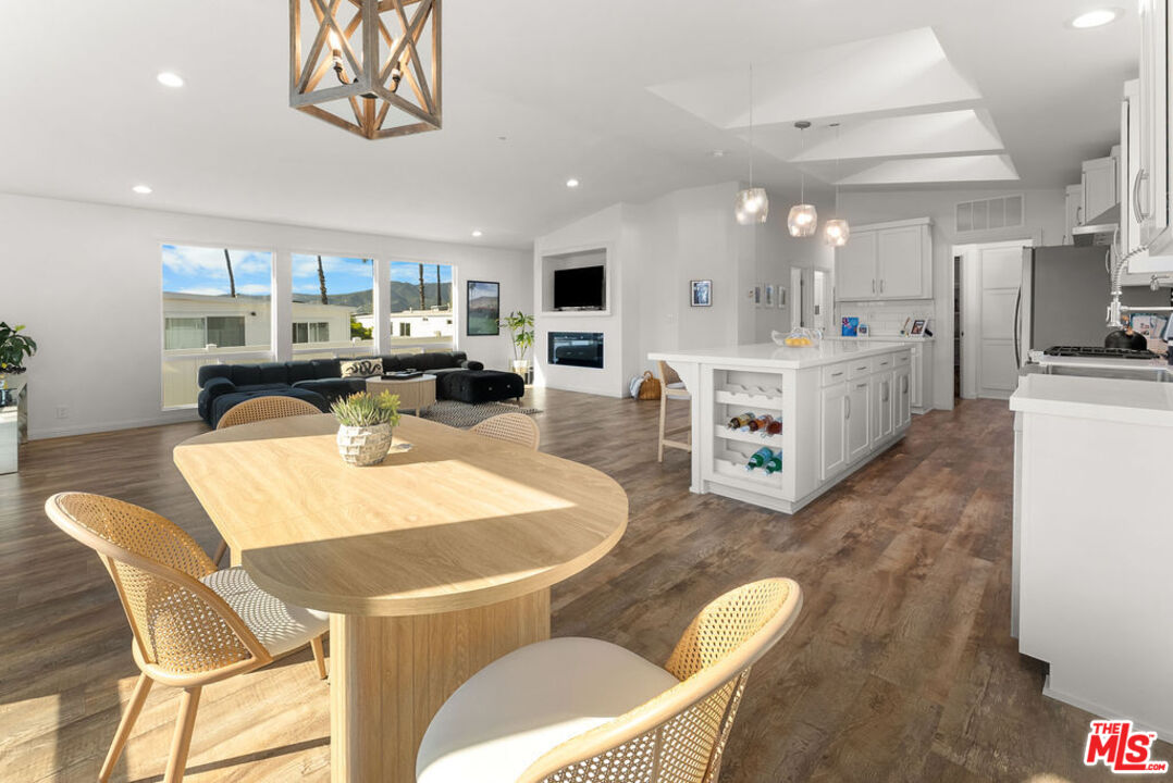 29500 Heathercliff Road, Unit 70 Malibu, CA 90265 - Photo 6 of 38 a living room with furniture a large window and kitchen view